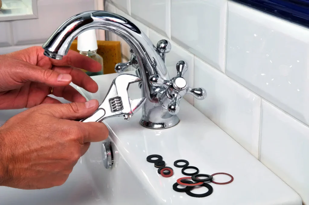 Plumber performing maintenance on a bathroom faucet in Tampa
