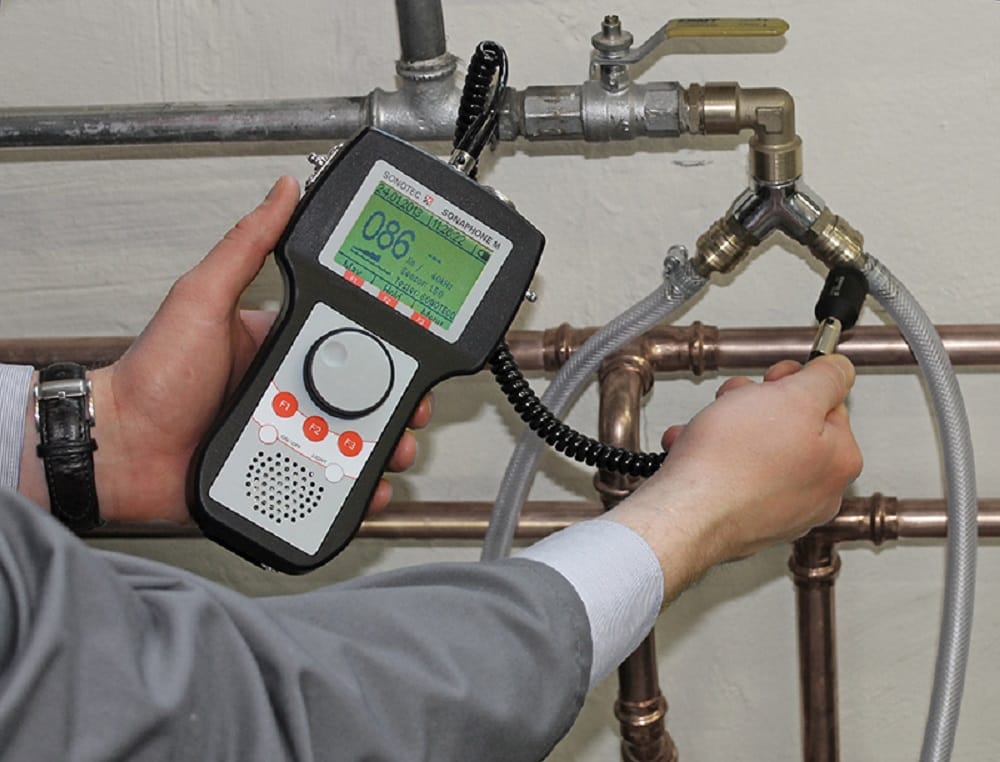 Plumber testing pipes with electronic leak detection equipment in Tampa