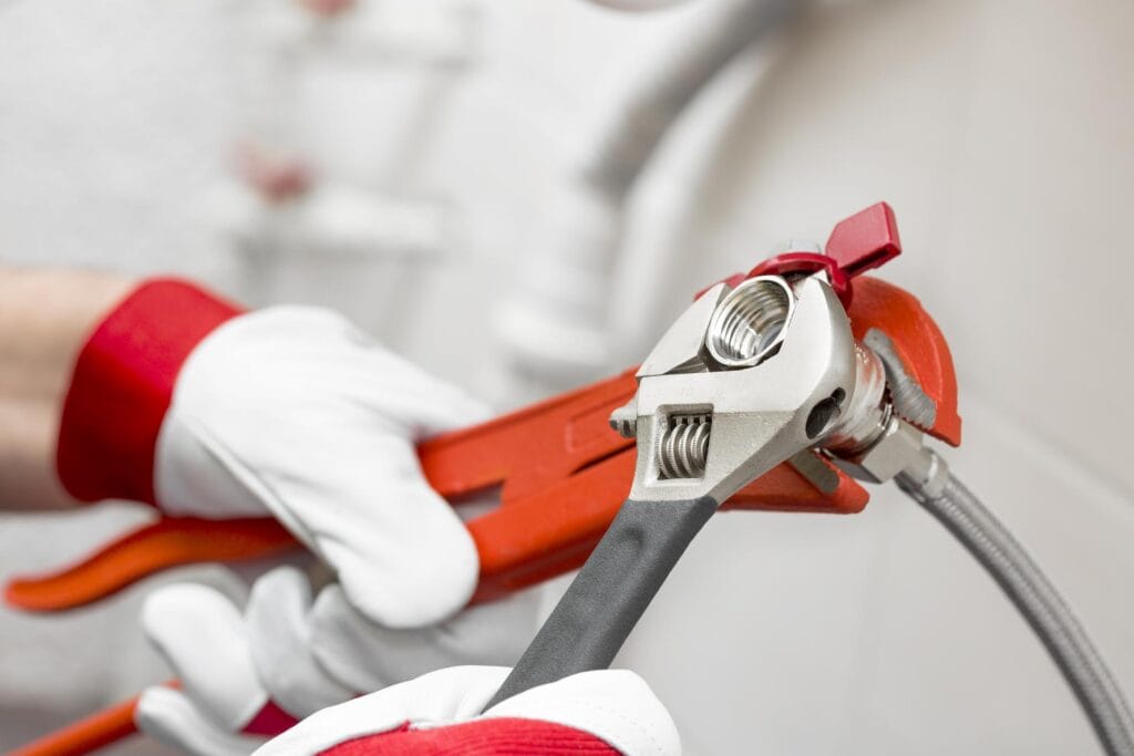 Plumber holding pipe wrenches for an emergency repair in Tampa