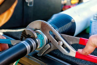 Technician tightening an industrial pipe connection in Tampa