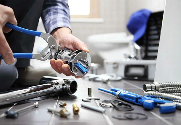 Technician repairing a plumbing fixture with professional tools in Tampa