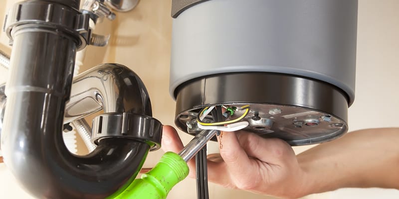 Technician repairing the heating element of a water heater in Tampa