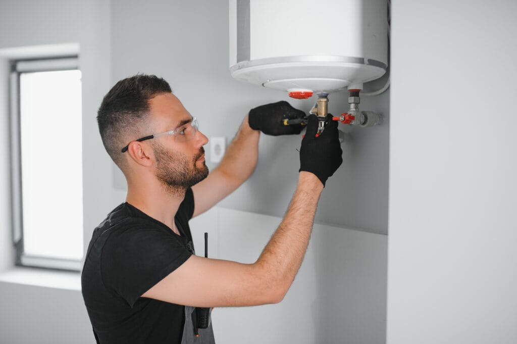 Technician performing water heater maintenance in Tampa