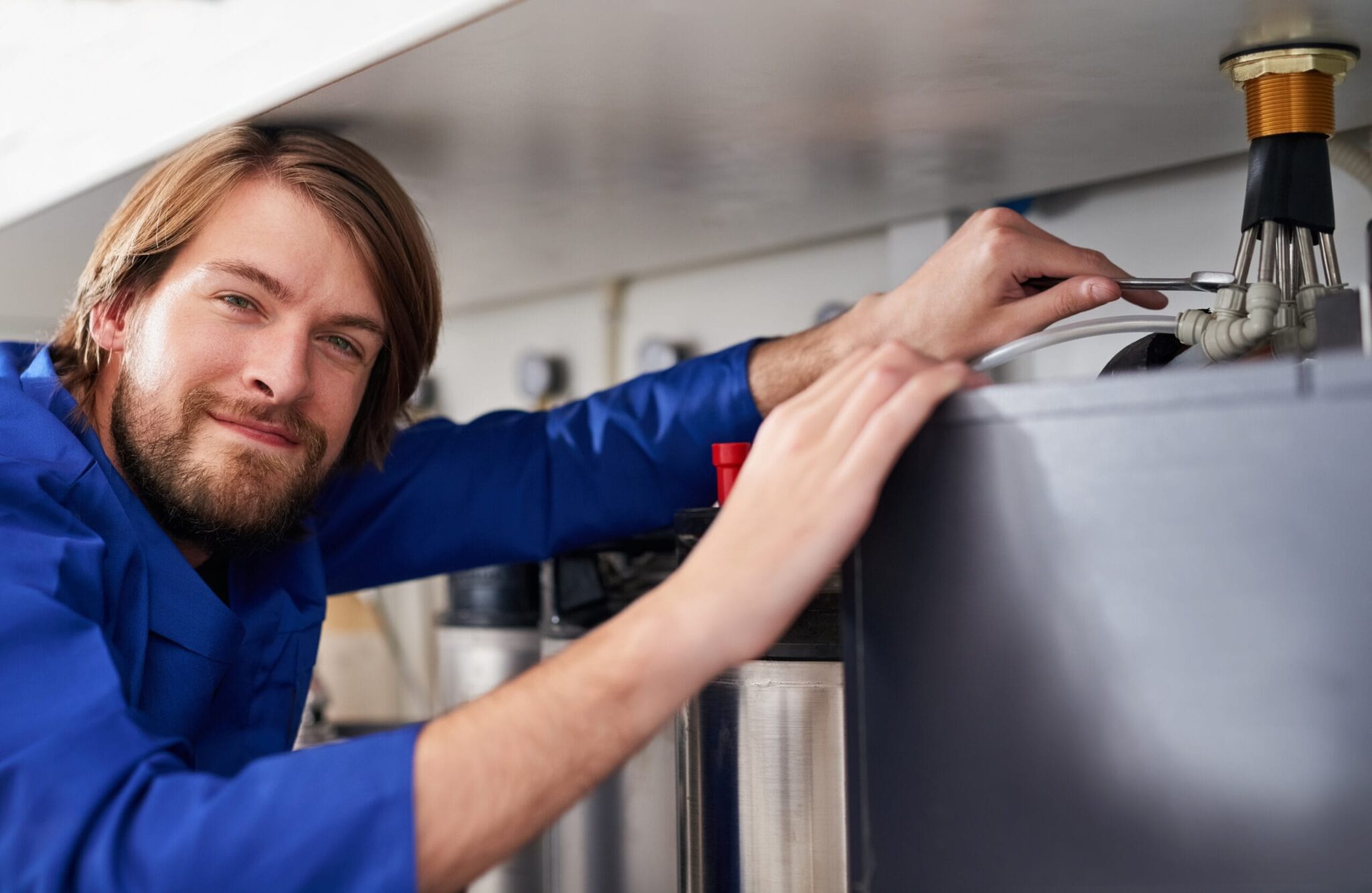 Technician servicing a residential water heater tank in Tampa