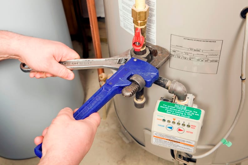 Plumber repairing a water heater valve in Tampa